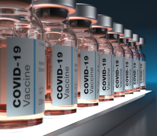 All Georgians over 16 eligible for COVID-19 vaccine Thursday PODCAST COVID-19 vaccines: Clear bottles of the pale pink liquid vaccine labeled and ined up on a shelf in a semi-dark room