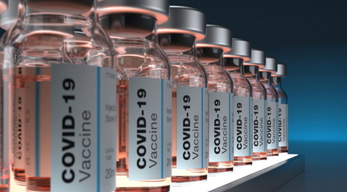 All Georgians over 16 eligible for COVID-19 vaccine Thursday PODCAST COVID-19 vaccines: Clear bottles of the pale pink liquid vaccine labeled and ined up on a shelf in a semi-dark room