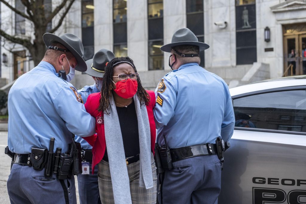 State Rep. Park Cannon, D-Atlanta, is placed into the back of a Georgia State Capitol patrol car after being arrested by Georgia State Troopers at the Georgia State Capitol Building in Atlanta, Thursday, March 25, 2021.