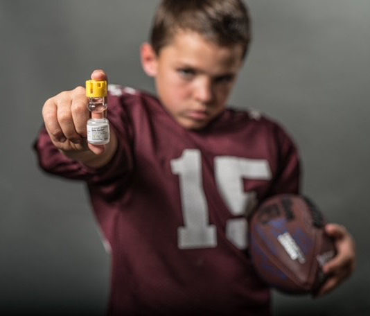 New bill would let Georgia paramedics administer lifesaving shot Jarom Bill: Little boy in burgandy football jersey #15 holding glass vial with yellow cap of Solu-Cortef