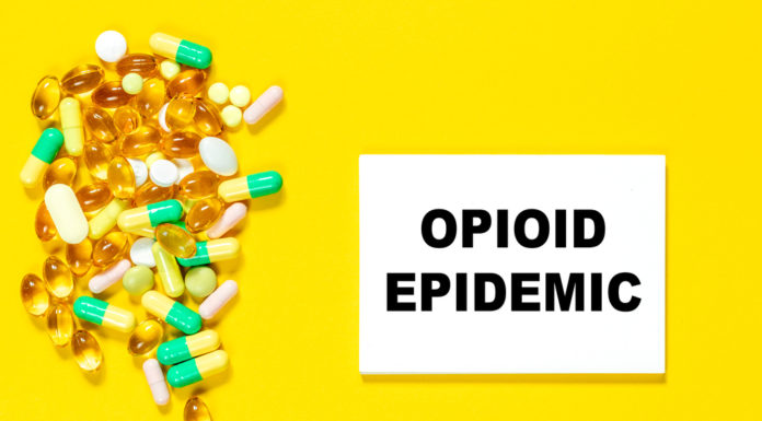 New Georgia bill addresses pandemic-driven increase in opioid deaths Poster with yellow background with pile of yellow, green, white and amber pills and black text "opioid epidemic"