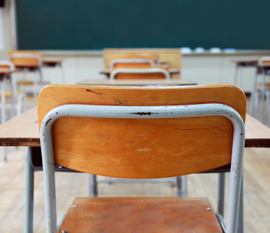 Senate approves $3,000-a-year credit for some teaching posts Rows of wood and metal student desks and chairs facing blackboard in a classroom