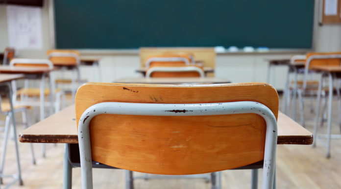 Senate approves $3,000-a-year credit for some teaching posts Rows of wood and metal student desks and chairs facing blackboard in a classroom