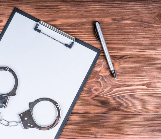 Fallout from Georgia’s new election law, an overhaul to the citizens arrest bill and more Handcuffs and clipboard with pen on wood table