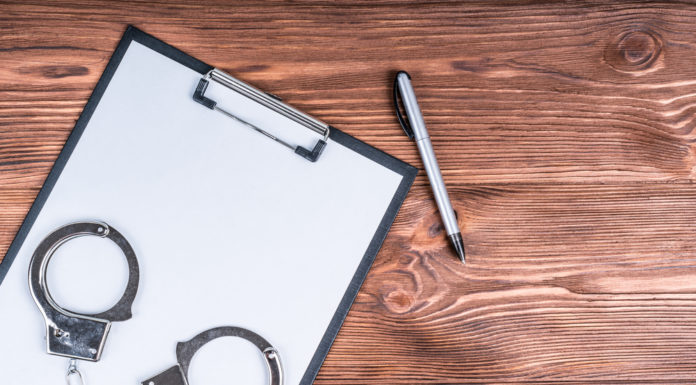 Fallout from Georgia’s new election law, an overhaul to the citizens arrest bill and more Handcuffs and clipboard with pen on wood table