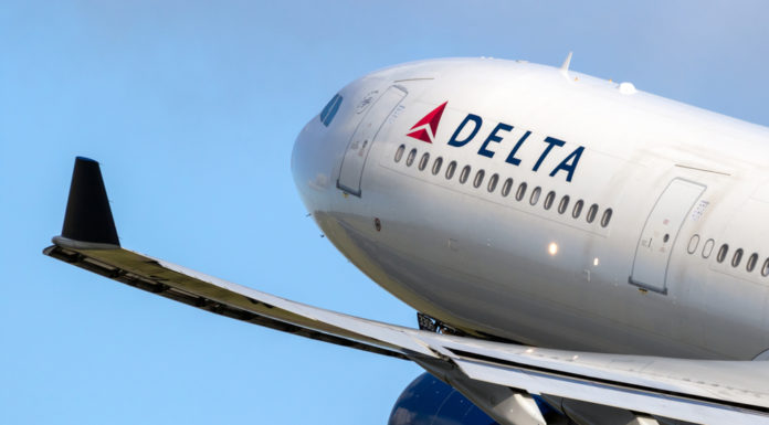 Corporations gave over $50M to voting restriction backers Closeup of Delta airplane taking off in clear blue sky