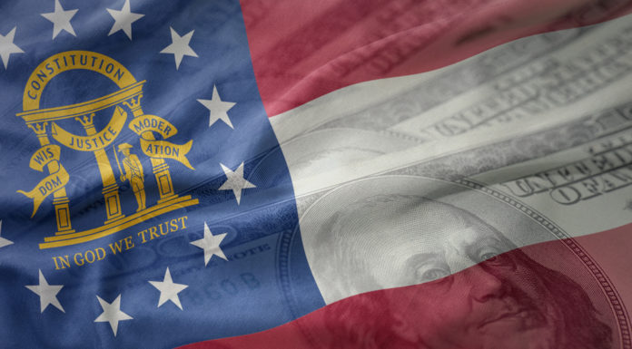 Kemp signs $27.3B state budget, will block police raises colorful waving flag of georgia state on a american dollar money background