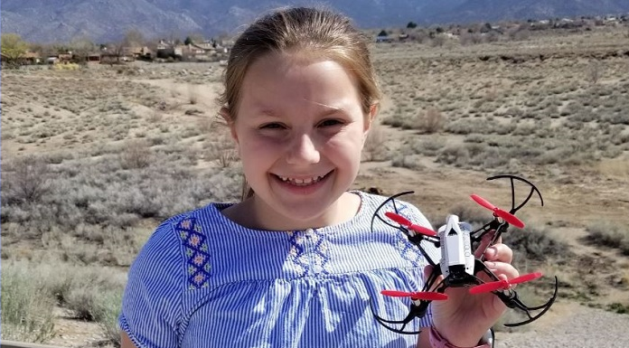 Georgia STEM Program Helps Girls Soar to New Horizons Georgia girls' STEM program:; young blonde girl in blue bouseholds her drone