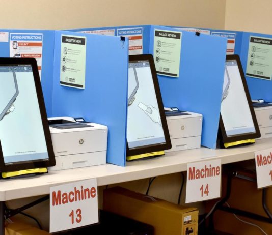 Here are all the lawsuits challenging Georgia’s new voting law Voting machines (electronic) with blue dividers between each