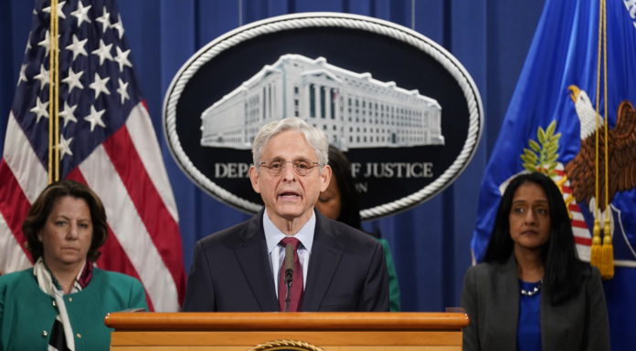 Justice Department suing Georgia over state’s new voting law Attorney general merrick garland at podium in front of white house seal