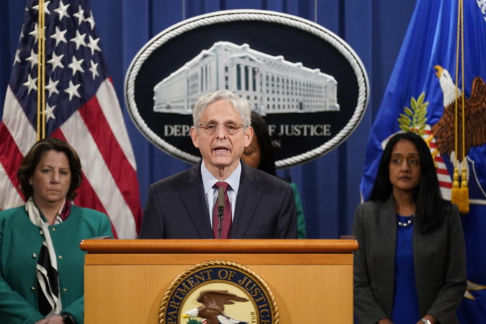 Attorney general merrick garland at podium in front of white house seal