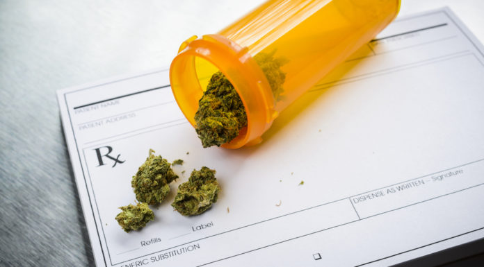 Card-carrying low THC oil patients have waited years to wait one more Marijuana in a prescription bottle on a prescription tablet