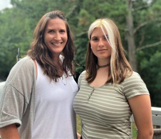 Social emotional learning debated at school board meetings Mother and daughter facing camera, dauther has white streak in hair