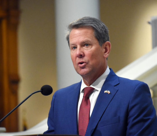 Kemp says Georgians can choose not to get vaccinated, but they may die of COVID-19 Gov. Kemp speaking at a podium