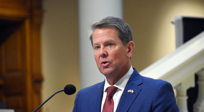 Pay boosts, refunds and increased school spending dominate Georgia budget week hearings Gov. Kemp speaking at a podium