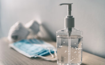 Gov. Kemp signs Unmask GA Students Act, Constitutional Carry passes House and Senate, voting bill controversy and more hand sanitizer and surgical mask on table