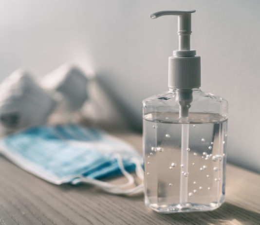 Gov. Kemp signs Unmask GA Students Act, Constitutional Carry passes House and Senate, voting bill controversy and more hand sanitizer and surgical mask on table