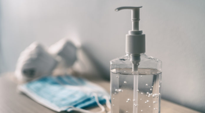 Gov. Kemp signs Unmask GA Students Act, Constitutional Carry passes House and Senate, voting bill controversy and more hand sanitizer and surgical mask on table