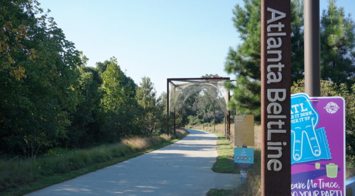 Atlanta Beltline expansion gives a different view A brown Atlanta Beltline pole in front of a sign with a upside down peace sign hand sign saying ATL hold it down pick it up