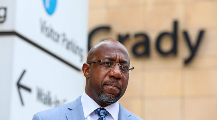 In battleground Georgia, candidates see big boost in campaign cash black man in suit with bald head tie in glasses in front of Grady Hospital