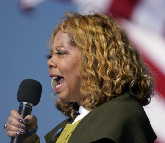 GOP looks to preserve majorities as Georgia remaps districts Georgia redistricting: Black woman with curly blonde hair wearing brown jacket and gold top speaking into microphone she is holding in right hand