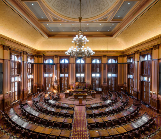 Georgia’s Sine Die: A transgender bill gets approved at the last minute and Gov. Kemp keeps his promise of a tax refund Georgia representative chambers with ornate antique furniture and traditional architecture