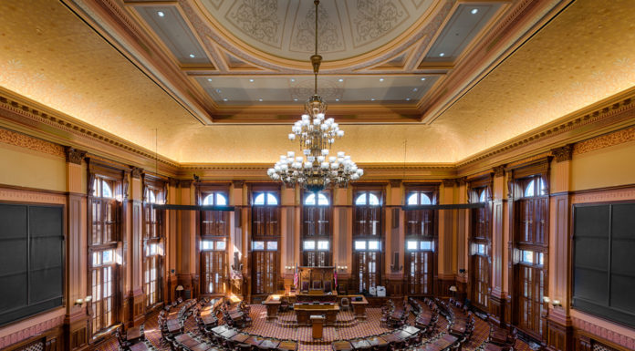 Georgia’s Sine Die: A transgender bill gets approved at the last minute and Gov. Kemp keeps his promise of a tax refund Georgia representative chambers with ornate antique furniture and traditional architecture