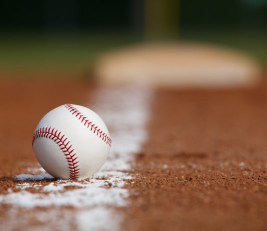 Legislators can’t contain excitement over World Series win Georgia General Assembly: baseball on white chalkline sourounded by brown dirt with base in the background