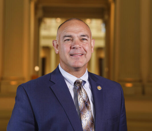 Georgia bill would ban abortion pills by mail, require exams white man smiling with navy blue jacket with light blue shirt with brown and tan colored tie