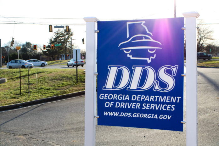 outdoor blue sign with big white letters with DDS and Department of Driver Services.