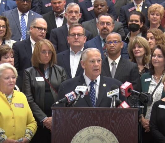 Speaker Ralston presents mental health bill at press conference White man with gray hair speaking with a group behind him