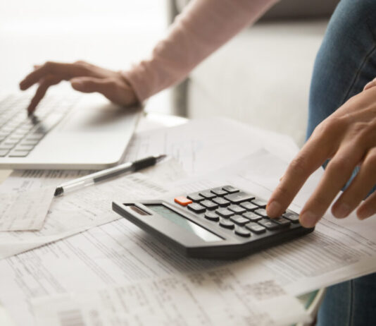 Budget week: How the state plans to address critical issues facing Georgians A person typing on a computer and using a calculator