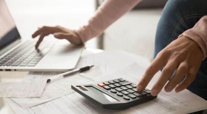 Georgia Senate approves budget maintaining higher spending A person typing on a computer and using a calculator