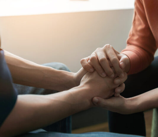 Advance directives for mental health could give those in crisis more options Two people holding hands in front of window