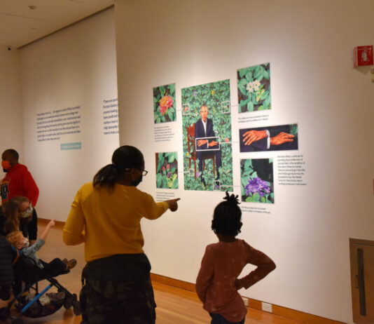 Obama portraits make historic stop in Atlanta Mother and daughter looking at a portrait of Obama