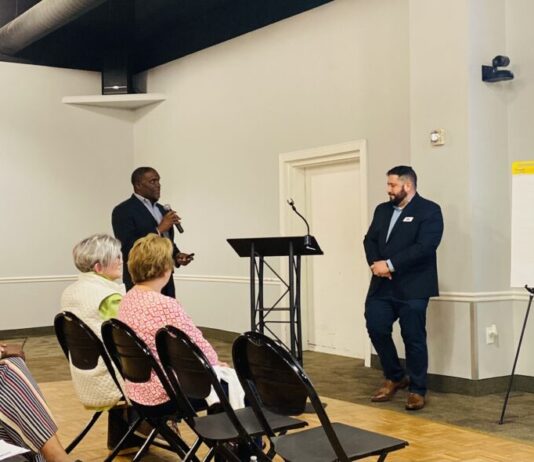Kennesaw officials look for public input on city planning Kennesaw's public engagement meeting: Black man and white man stand presenting to seated audience