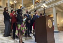 Georgia GOP lawmakers draw districts in Democratic counties A group of Georgia Legislatures at the state capitol speaking at the steps.