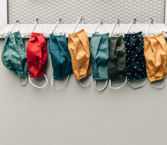 Georgia Senate seeks to let parents nix masks through 2027 Multiple colored masks hanging up on along a coat hanger.