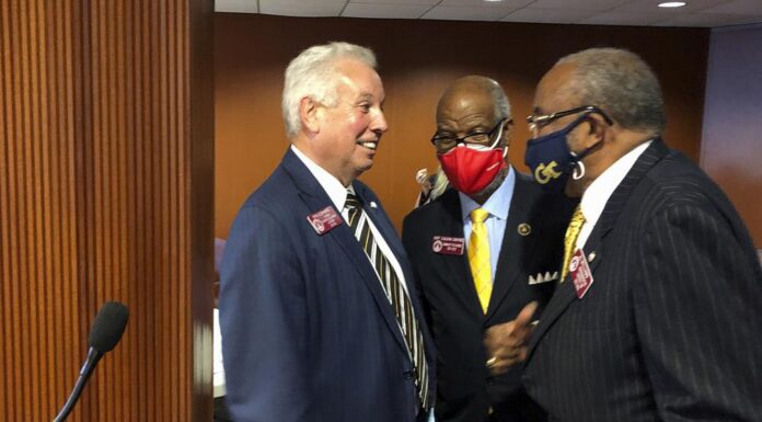 Georgia House panel backs referendum to legalize gambling White man and two black men talking to each other