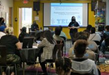 Marietta youth organization hosts community discussion on redeveloped Franklin Gateway White woman wearing a face mask speaking to a crowd of people indoors