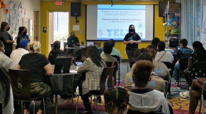 Marietta youth organization hosts community discussion on redeveloped Franklin Gateway White woman wearing a face mask speaking to a crowd of people indoors