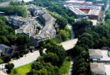 Atlanta’s BeltLine shows how urban parks can drive ‘green gentrification’ if cities don’t think about affordable housing at the start Aerial view of paved out pathway surrounded by green trees and housing to the left of the path