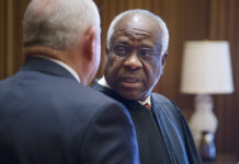 Bill to install a monument of Clarence Thomas at Georgia Capitol stalls African American man in balck robe speaks in from of white man in black suit
