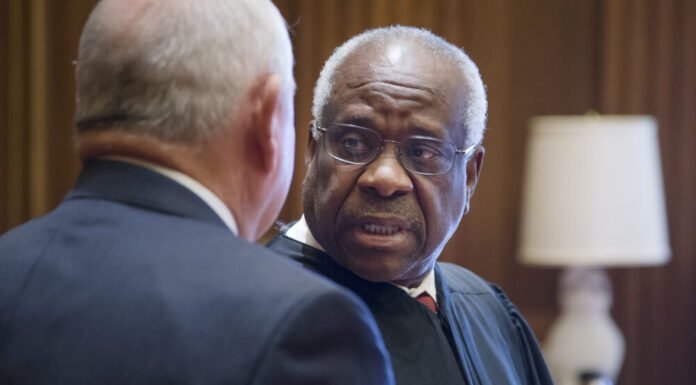 Bill to install a monument of Clarence Thomas at Georgia Capitol stalls African American man in balck robe speaks in from of white man in black suit