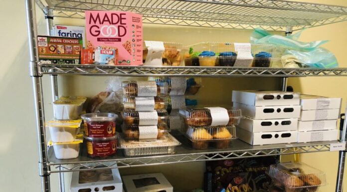 Georgia lawmakers look for ways to eradicate hunger across state. Metal shelf stocked with various food items against beige wall.