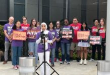 Cobb County students organize against divisive concept bans Woman in hijab speaks outside in front of microphone with a group of supporters behind her in casual clothes