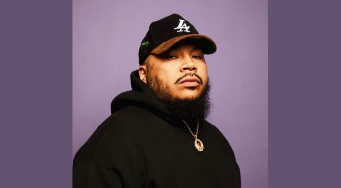 Everyday Hero: Kali Cunningham’s non-profit gives back to the community Headshot of Kali Cunningham, a young adult male with Los Angeles Dodgers hat and black beard wearing black hooded sweatshirt and a gold chain against a plain purple background.