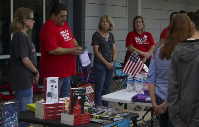 A man wearing a red shirt that reads 