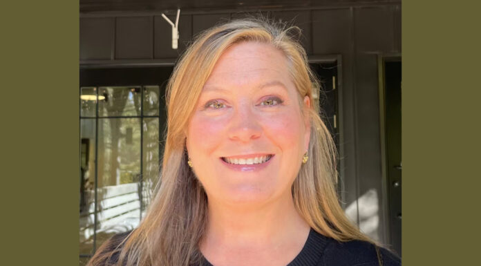 Everyday Hero: Animal lover’s nonprofit helps thousands of furry friends A profile photo of a blonde woman with long hair smiling at the camera. She is wearing a black sweater and small gold earrings. She is standing in front of a dark green building.