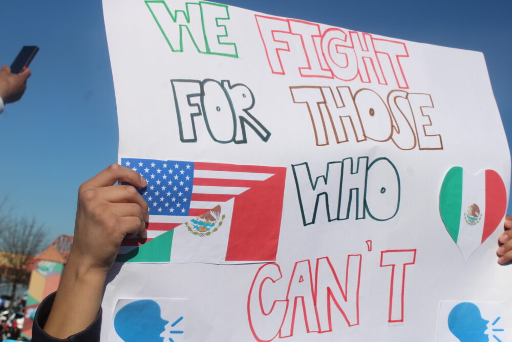 Protester holding a sign "We fight for those who can't" (Zaire Breedlove/ Fresh Take Georgia).